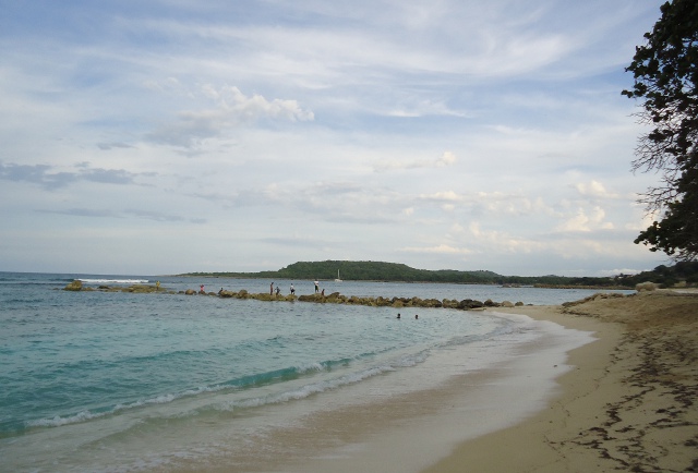 From the La Playa Grande you can see a catamaran entering Luperon harbor in the distance.